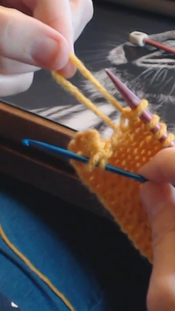 using the crochet hooks to bring stitches up rows