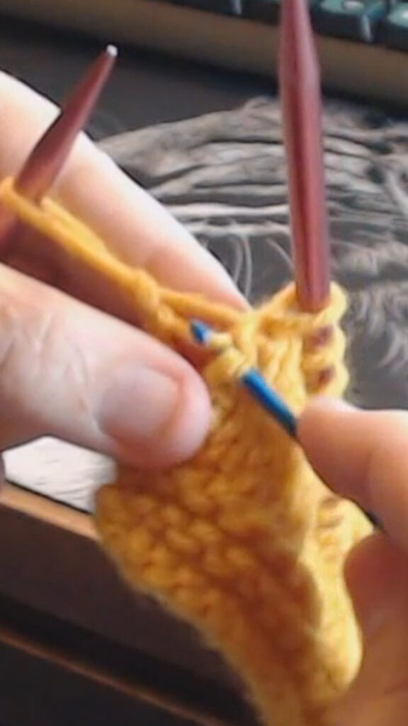 using a crochet hook to repair a dropped stitch