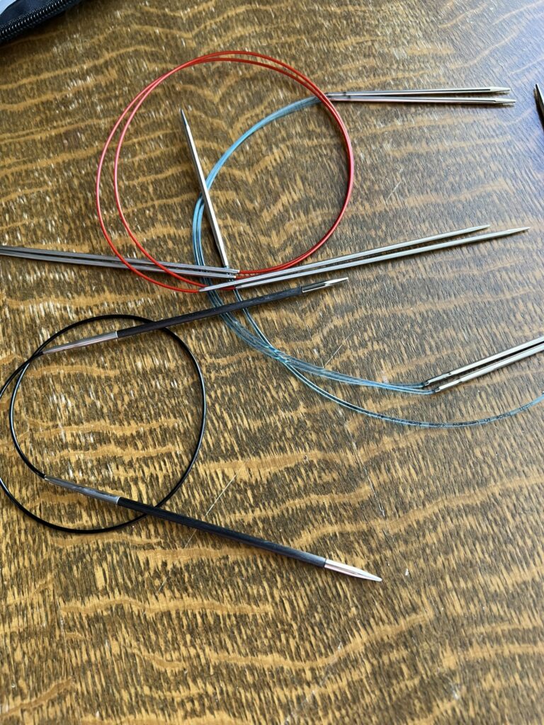 circular knitting needles with their cables coiled up