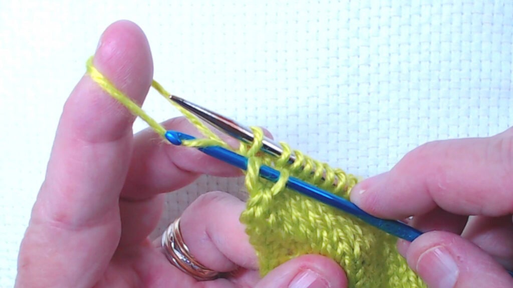 pulling lower bar though the outer stitch only