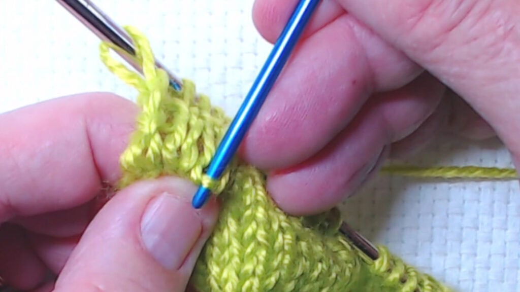 tugging on the bars inside the V stitches