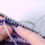 pointing at purl stitches on needle
