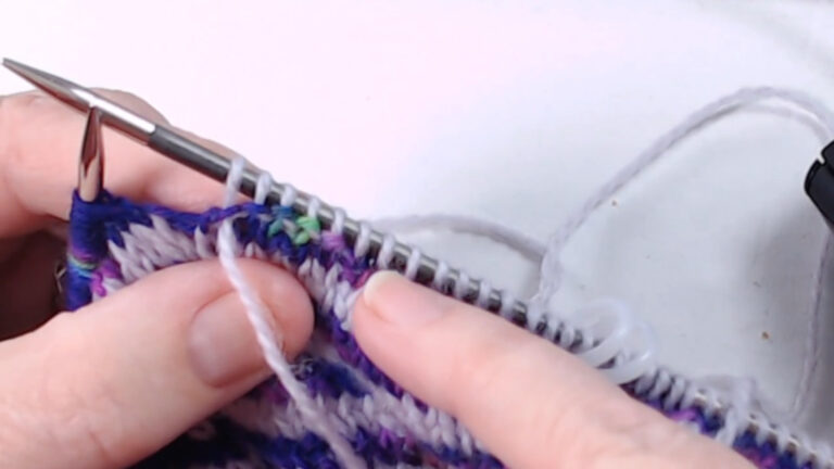 pointing at purl stitches on needle