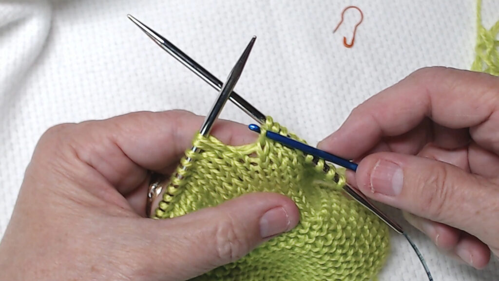 crochet hook bringing stitch up a row