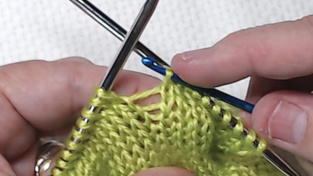 crochet hook bringing yarn through loop