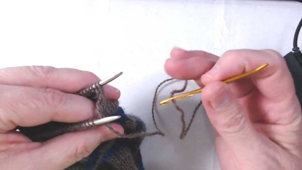 pulling darning needle through