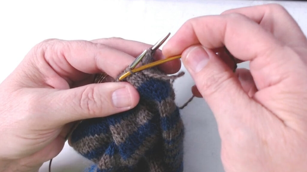 darning needle going into stitch