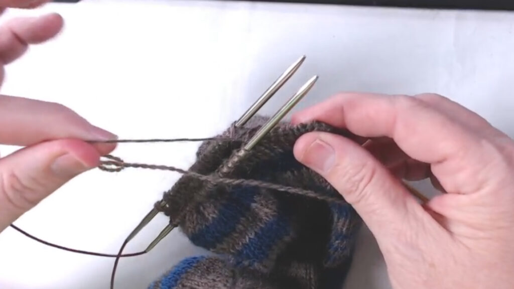 pulling on thread to tighten up the seam