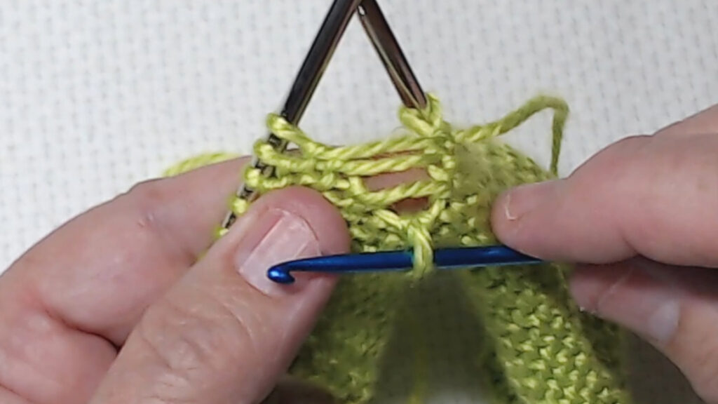 crochet hook catching dropped purl stitch