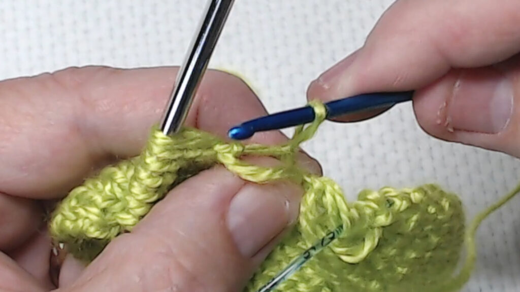 holding hook in back to bring bar through loop